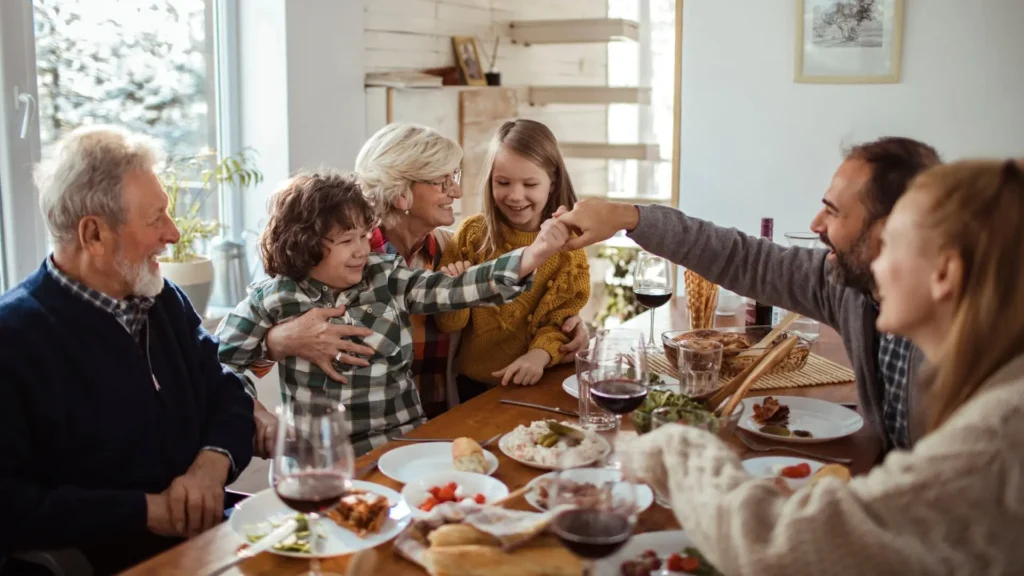 Famille réunie autour d'un repas, illustrant les facteurs de risques cardiovasculaires liés au mode de vie et aux antécédents familiaux